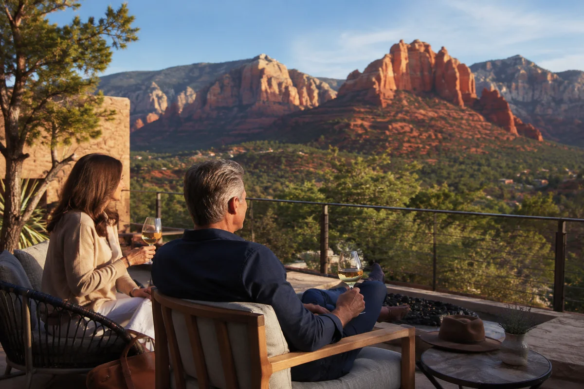 Couple relaxing with wine overlooking the red rock formations of Sedona, Arizona