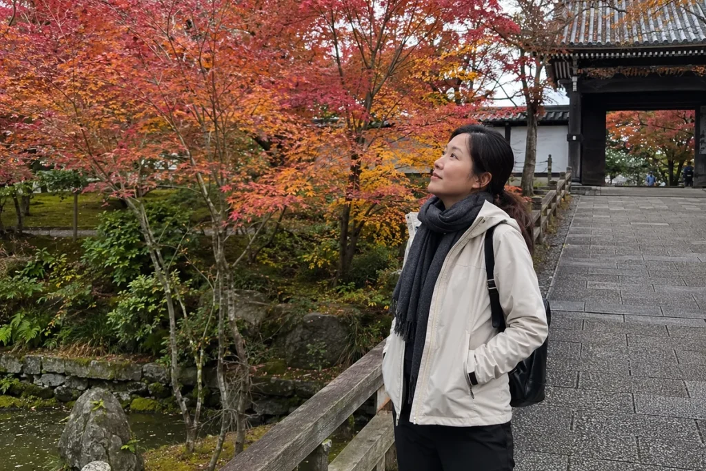 Client gazing up at vibrant autumn maple trees in a Japanese temple garden, effortless exploration through Japan client testimonial photo